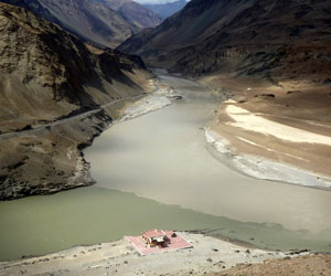The confluence of the Zanskar and Indus Rivers in Ladakh, India. The Zanskar river looks like milky coffee due to its high sediment load, and it creates mixing eddies as it joins the much clearer Indus coming from the bottom left