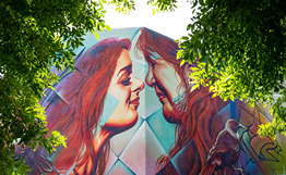 mural of two people performing a hongi