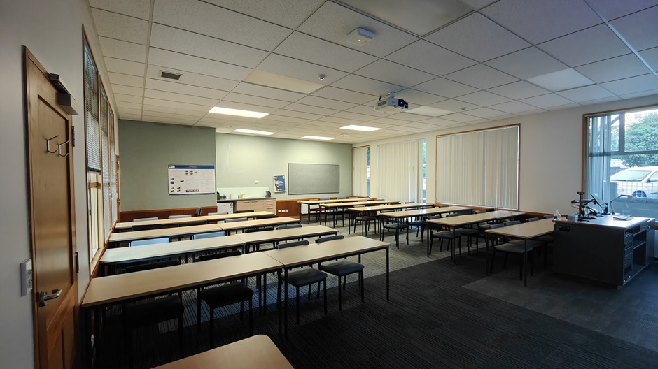 A view of Ōwheo building seminar room G34, showing rows of tables and chairs