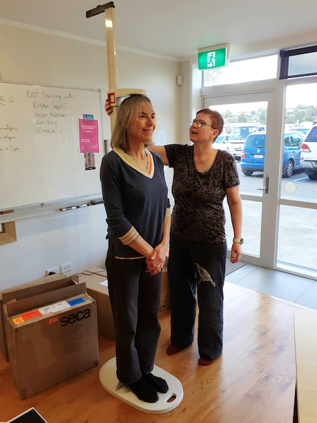 Height measurement of participant being taken by researcher