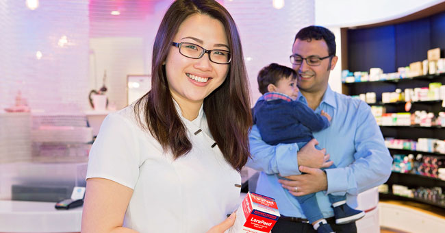 Pharmacist holding a box of medicine.