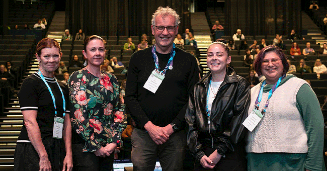 four people standing