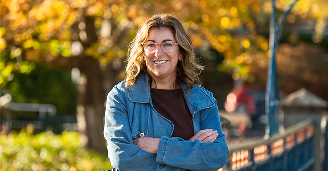 Dr Megan Pōtiki is pictured against an autumnal background. 