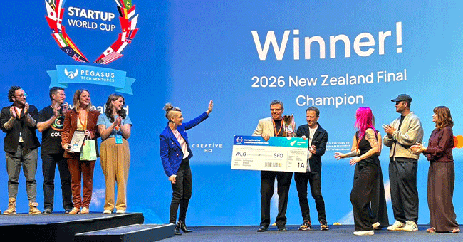 Professor John Reynolds on stage with novelty boarding pass