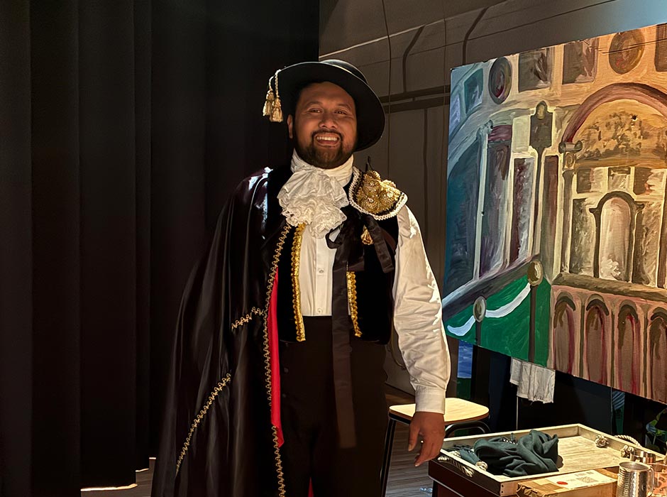 A man dressed in costume is pictured backstage at an opera.
