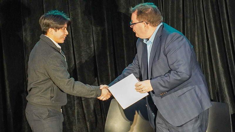 men shaking hands during award presentation