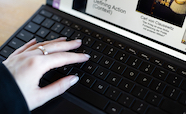 Hand on laptop keyboard thumb