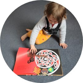 Small child looking at a picture book image