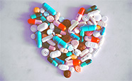 An assortment of pills arranged in a heart shape thumbnail