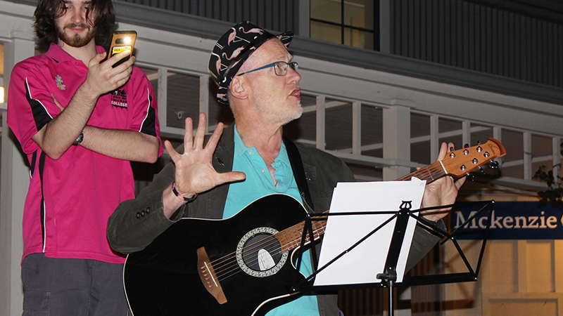 Chris Addington performing with his guitar