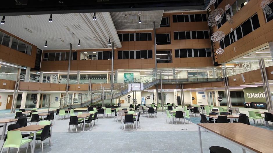 View of Otago Business School atrium, showing tables and chairs in groups