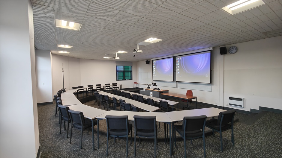 View of Otago Business School room LG04, showing tables and chairs in a small lecture theatre layout