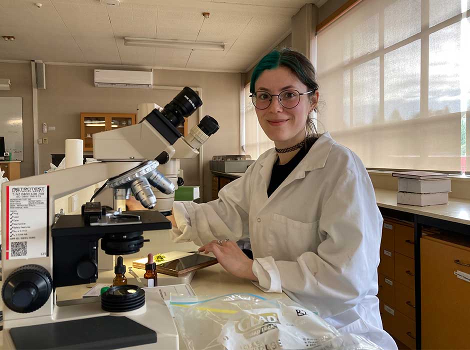 a woman using a microscope
