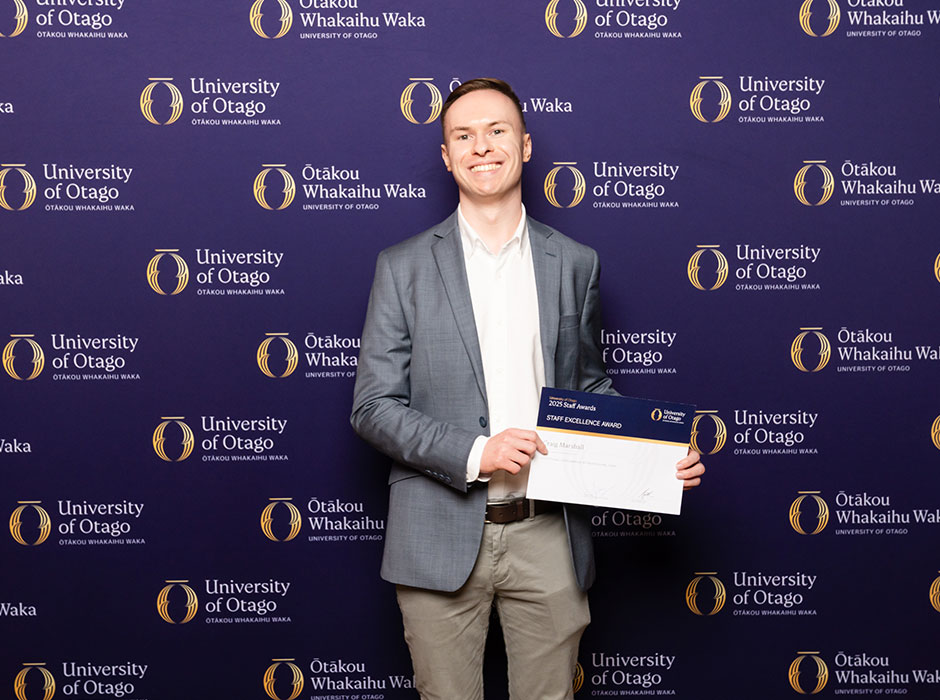 a man holding a certificate 