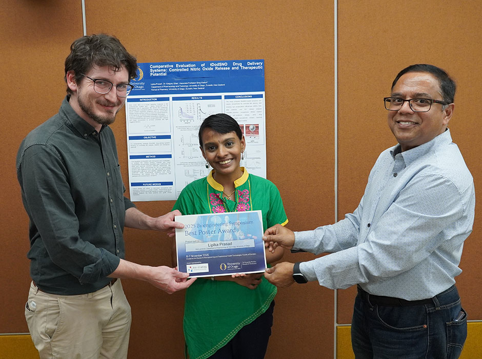 three people holding a certificate 