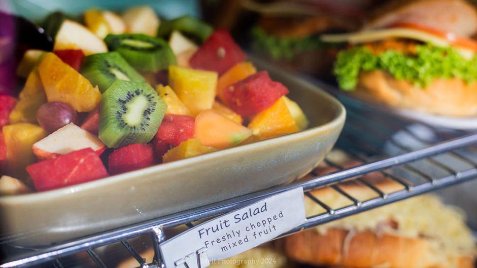Fruit salad and filled rolls on display in the Cafe Albany food cabinet
