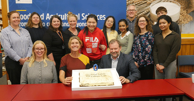 people gathered around a cake