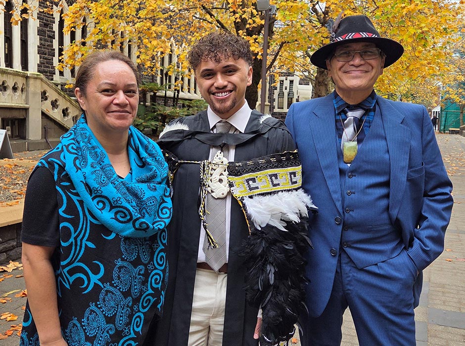 A new graduate is pictured with his mum and dad.