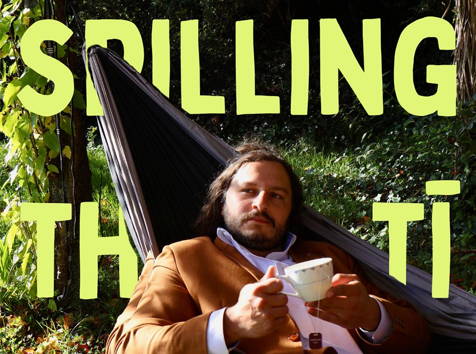 A man holding a cup of tea sitting in a swing chair with the words spilling the ti written across the picture