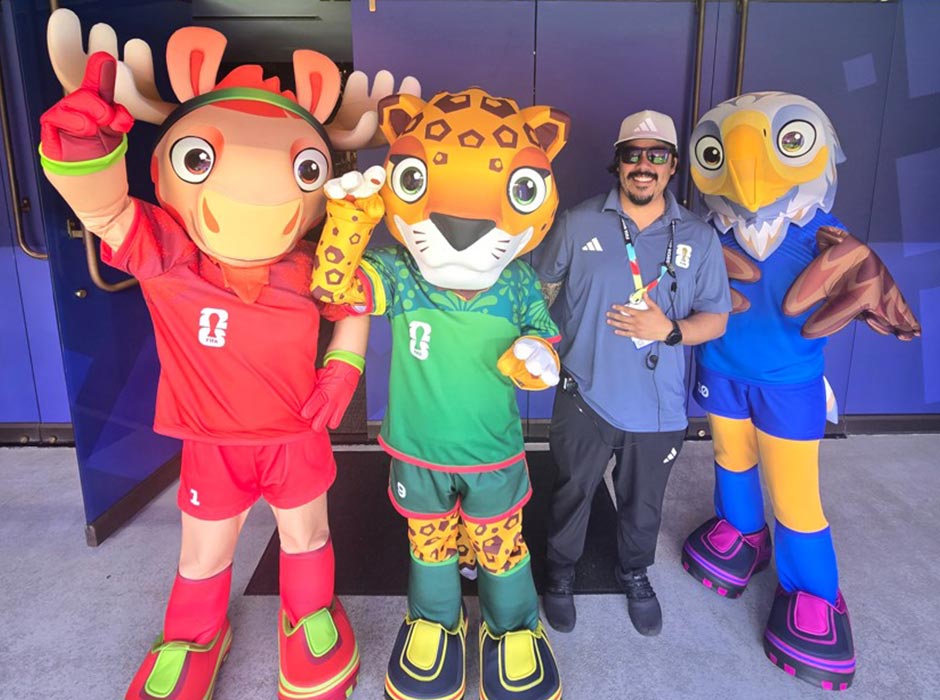 Man with three 2026 FIFA World Cup mascots
