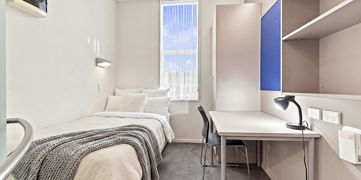 Student bedroom with single bed and desk