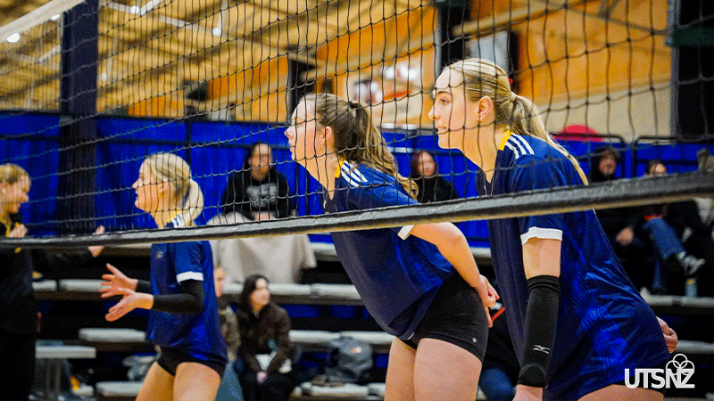 three women at a volleyball net