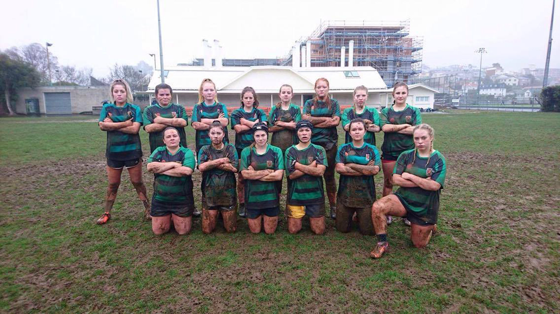 Women's Rugby Team covered in mud