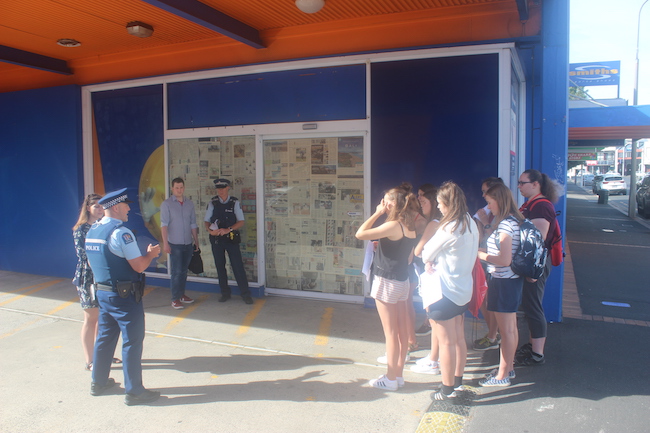 Students look on as Police arrest two law staff during a role play