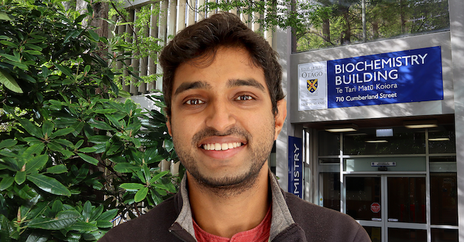 Zohaib Rana in front of biochemistry building entrance.