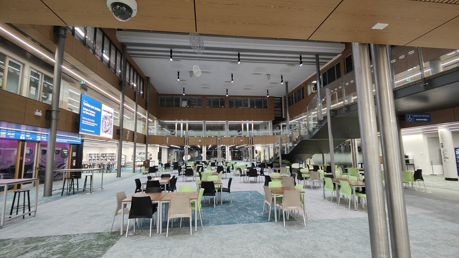View of Otago Business School atrium, showing tables and chairs in groups