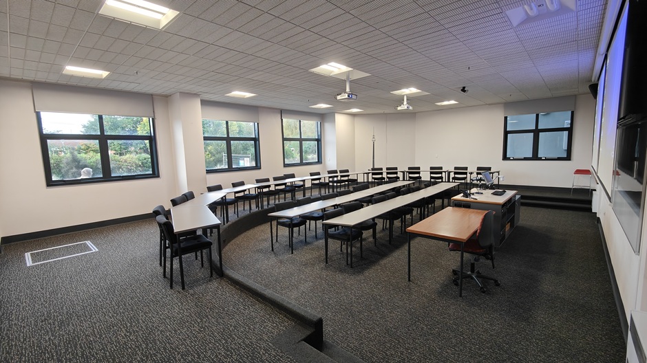 View of Otago Business School room LG04, showing tables and chairs in a small lecture theatre layout