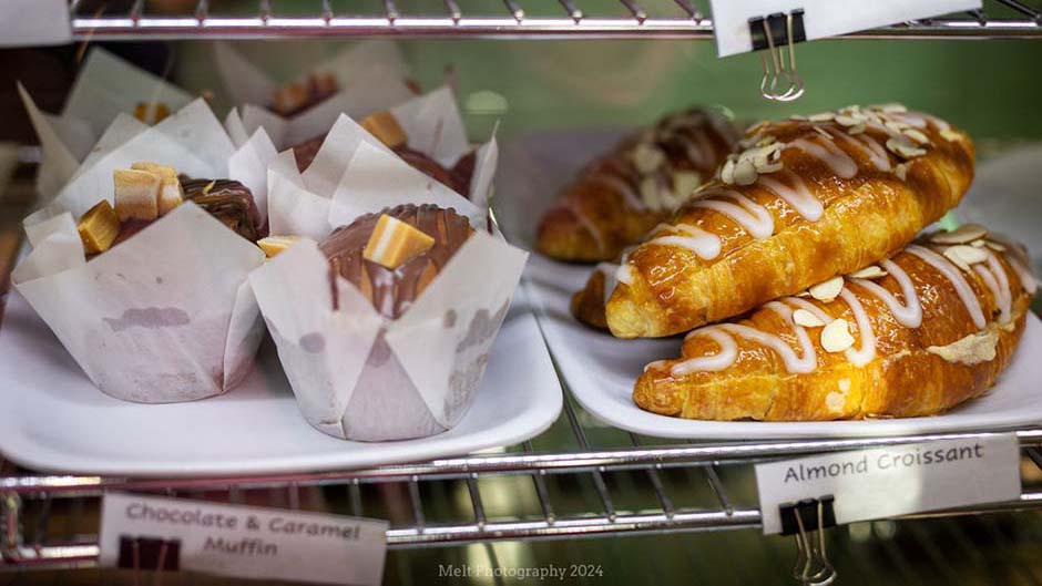 Sweet muffins and croissants on display in the Cafe Albany food cabinet
