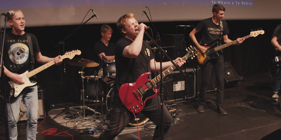 A group of students performing in a rock band