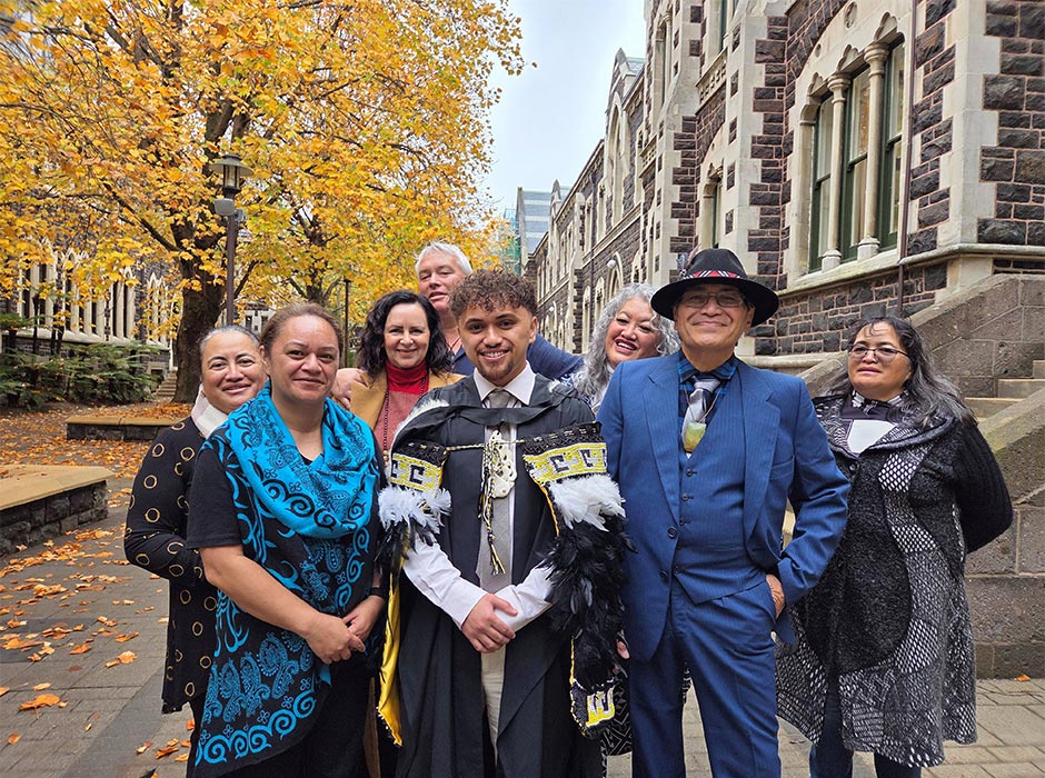 A new graduate is surrounded by his supporters.