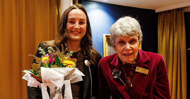 Dr Stephanie Waller is presented with a certificate by Dame Margaret Sparrow.