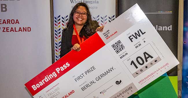 A woman holding a large oversized air plane ticket