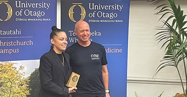 Professor-Lutz-Beckert-and-Amber-Philpott holding an award