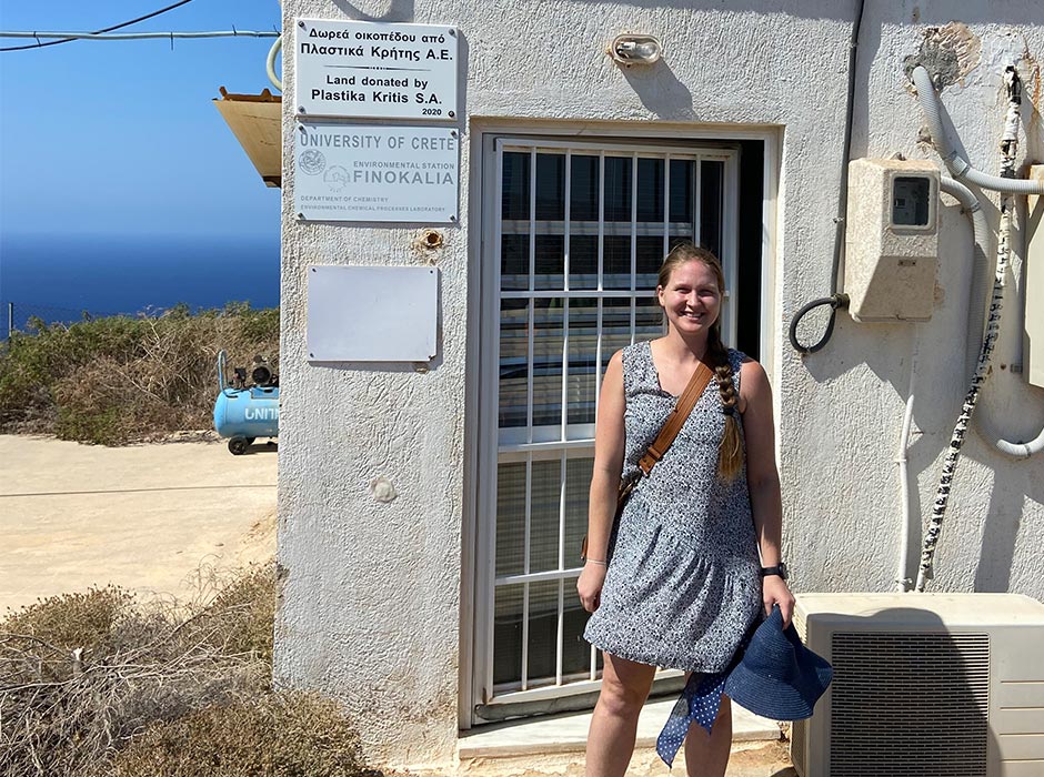 A woman is pictured by a Greek building.