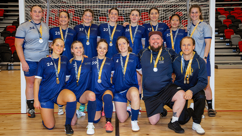 a womens futsal team in front of a goal