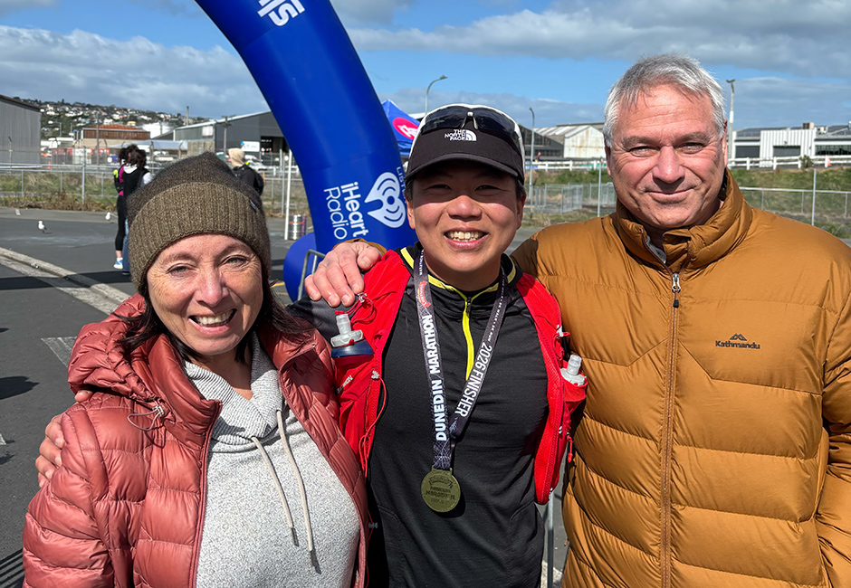 Homestay student stands with homestay family after finishing a running event.