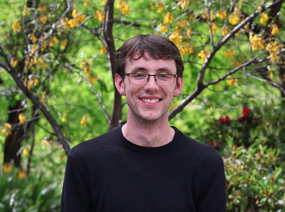 Carlo Gamble is pictured in front of greenery.
