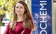 Sarah Diermeier standing outside in front of the Department of Chemistry sign