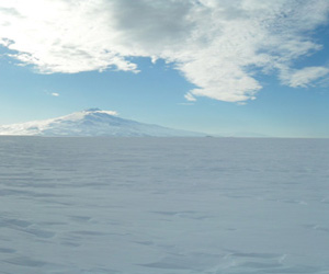 The vast emptiness of the Ross Ice shelf is interrupted by Mt. Terror on the horizon. Ross Ice Shelf, Antarctica.