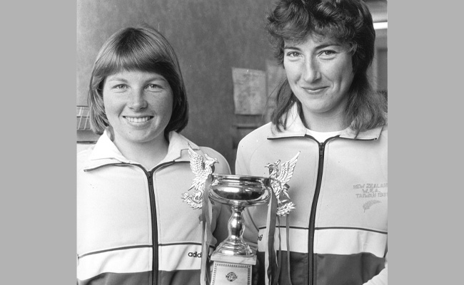 two women holding a trophy (black and white image) 