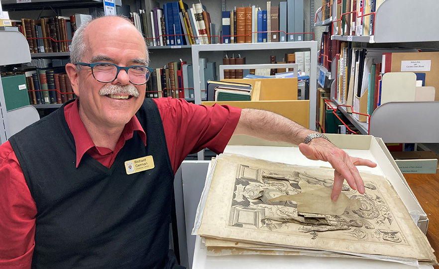 Richard German with a visibly aged centuries-old ‘pop up’ anatomy plate in Health Sciences library image