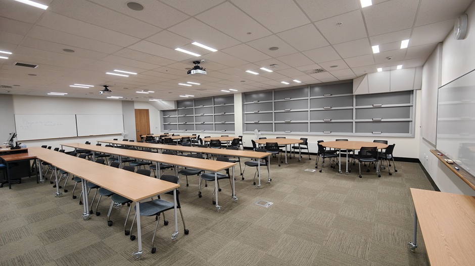 View of Otago Business School room 119, showing tables and chairs in rows and groups