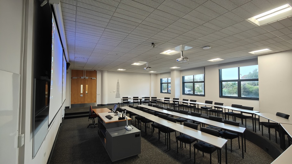 View of Otago Business School room LG04, showing tables and chairs in a small lecture theatre layout