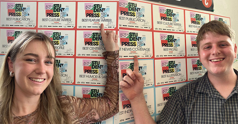 A woman pointing to a certificate on a wall, a man pointing to a certificate on a wall