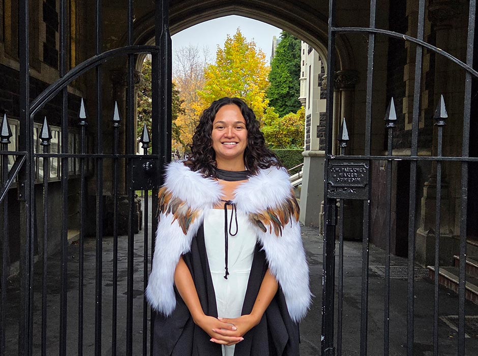 A young woman poses in her graduation wear.