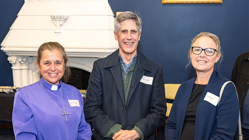 Two women and a man are pictured at an event.